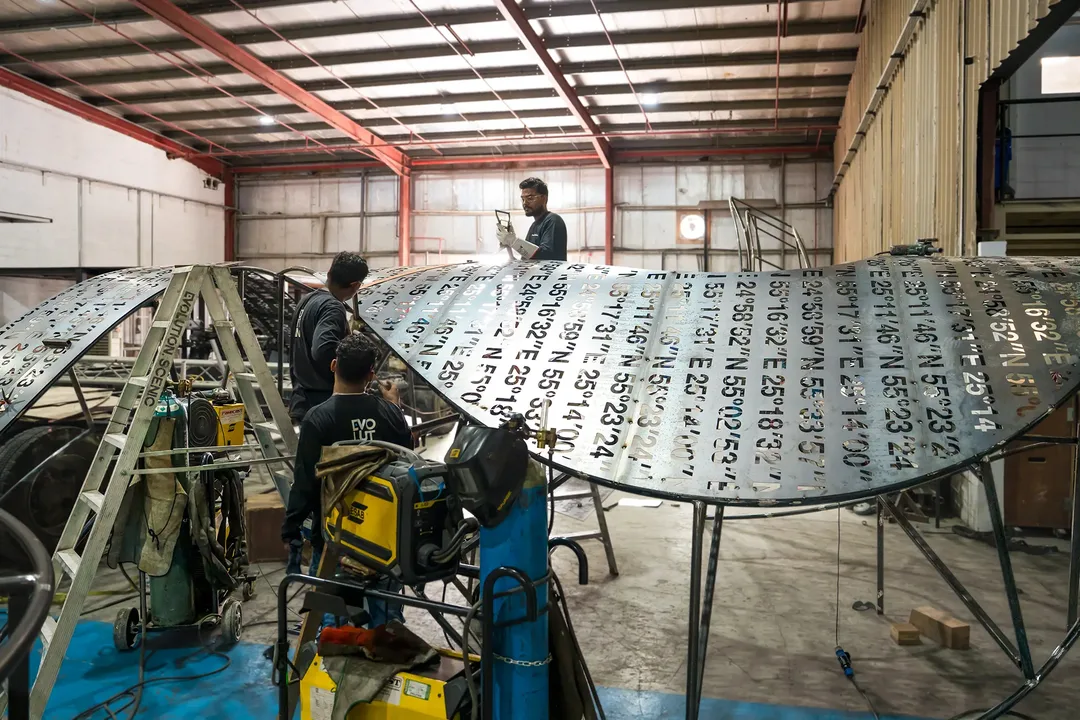 Designer, engineer and fabricator coordinating structural details around a scenic mock-up.