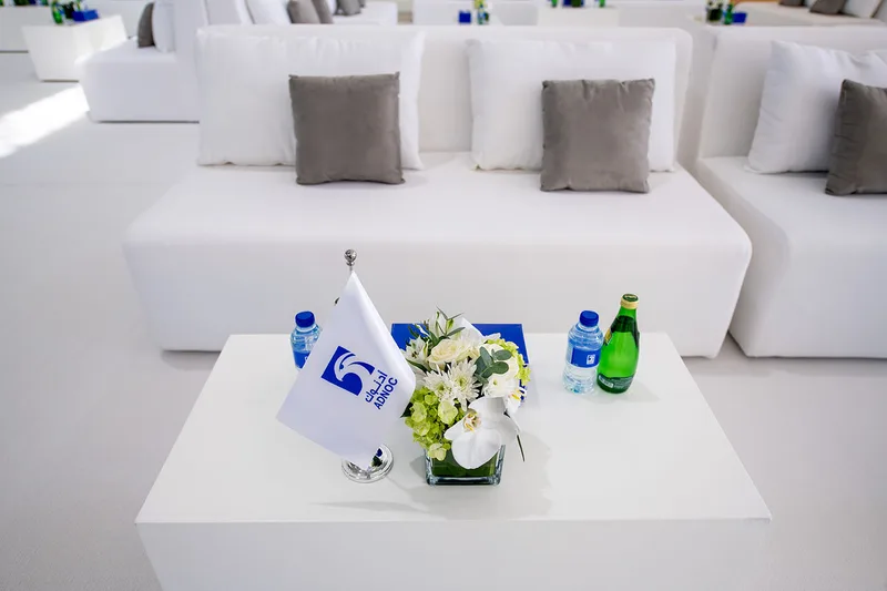 Custom sofa seating and floral displays supplied by Evolution Furniture.