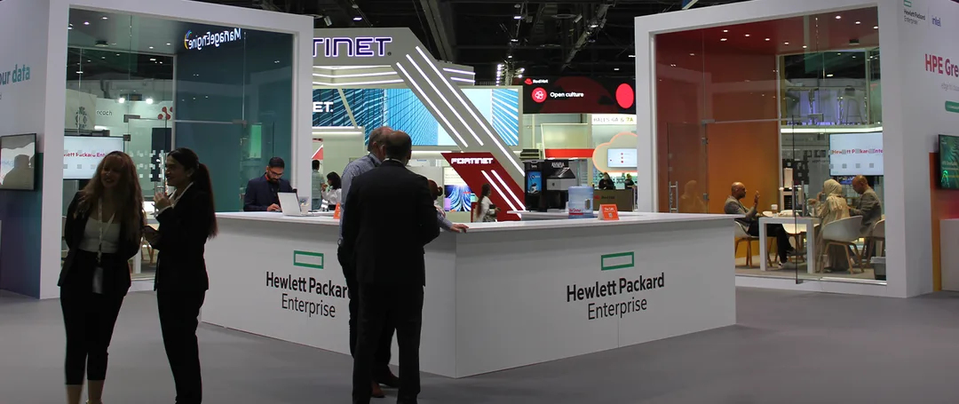 Completed HPE GITEX Dubai stand with bespoke scenic structures and glazed meeting-room architecture.