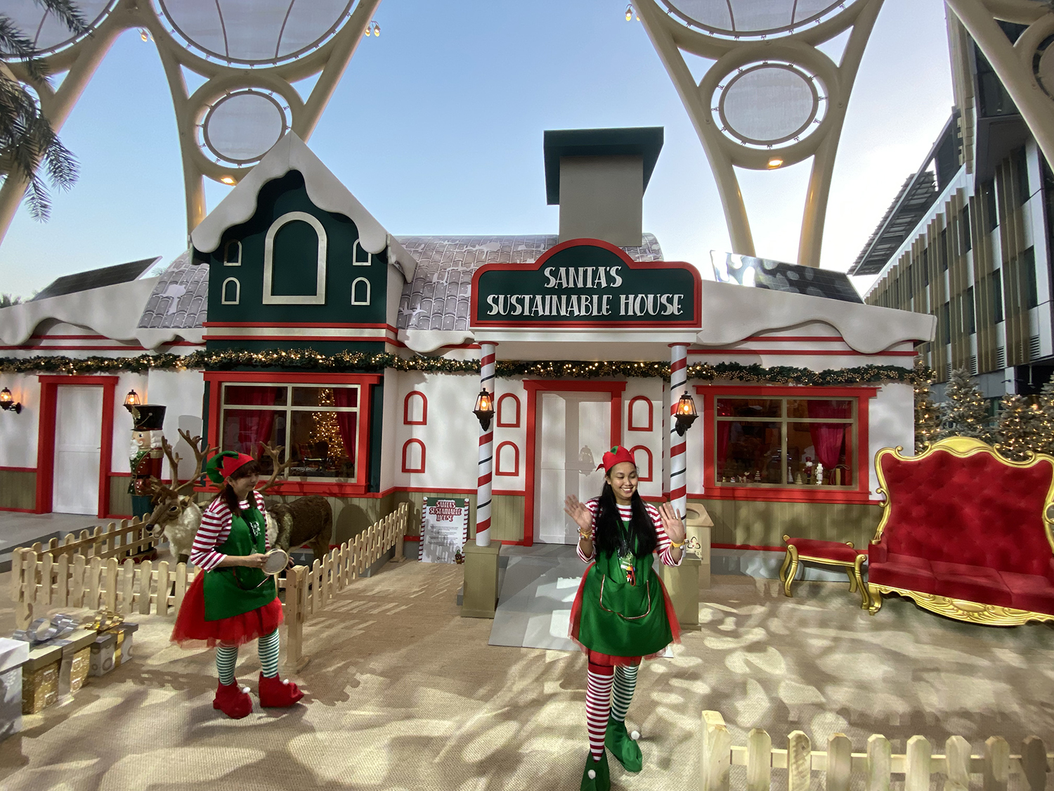 Evolution Scenic Santa’s Sustainable House with snowy roofs and candy-cane entrance columns.