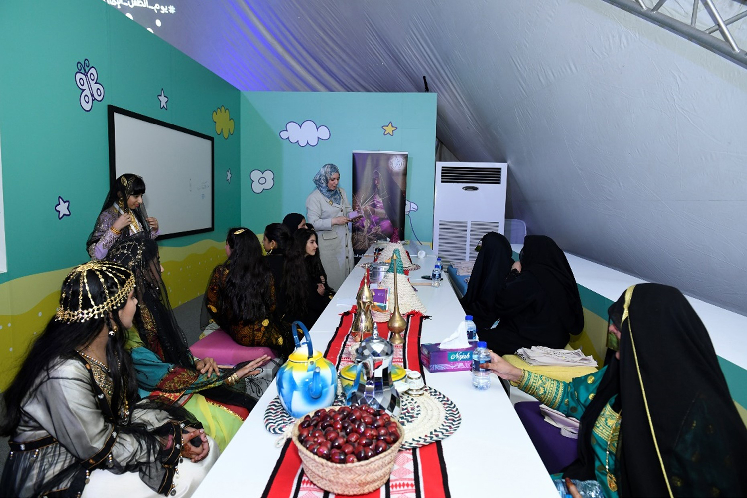 Custom workshop wall panels with playful graphics inside the festival tent.