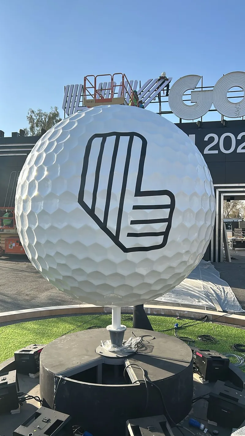 Two-metre fibreglass golf-ball sculpture mounted within the custom circular scenic platform.