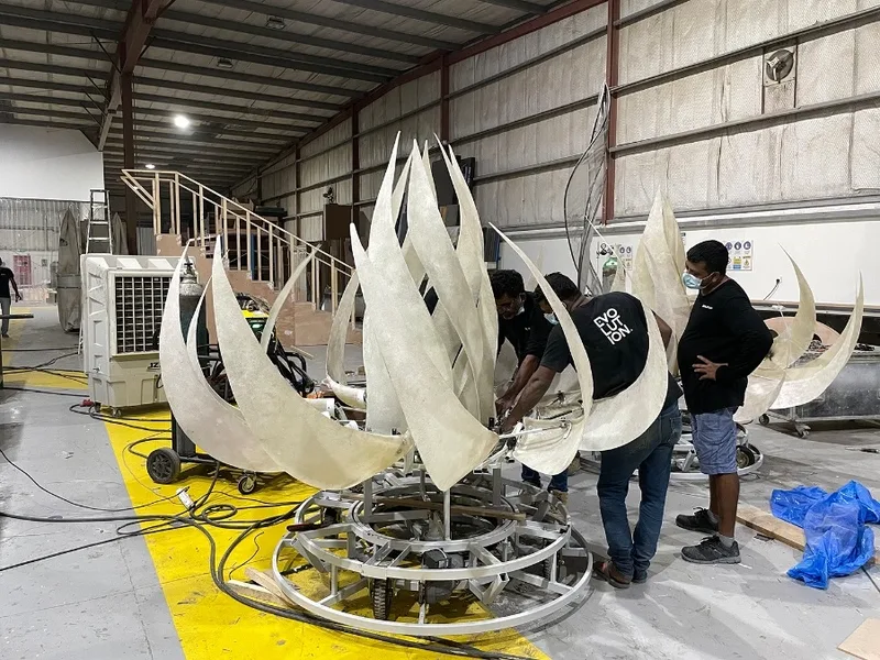 Large mechanised flower sculpture mounted on a mobile circular performance base.