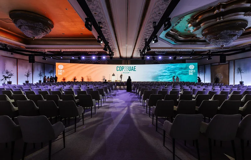 Twenty-nine-metre curved LED display aligned with the custom conference stage.