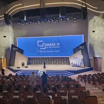 Evolution Scenic angular main stage with integrated screen and illuminated detailing in Abu Dhabi.