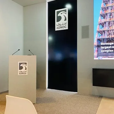 Painted MDF scenic structures forming the ADNOC presentation and exhibition environment at ADIPEC Abu Dhabi