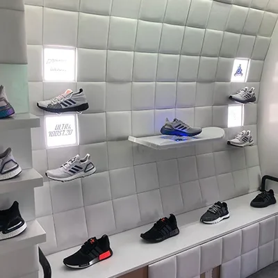 adidas-sneaker-retail-display-illuminated-wall.webp
