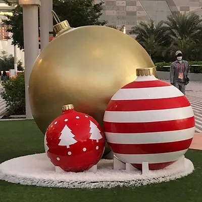 Refurbished giant Christmas bauble seating pod surrounded by decorative ornament props