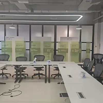 Green-tinted acrylic workshop stand with transparent graphics and printed MDF backdrop.