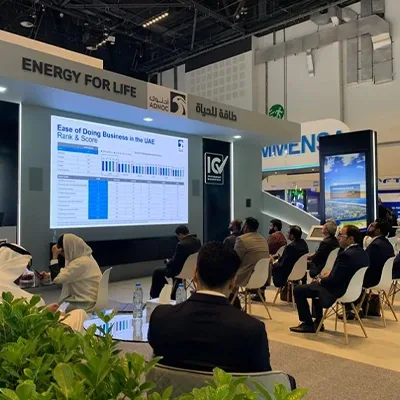 MDF scenic cladding and black architectural structures surrounding integrated digital screens at ADIPEC 2022