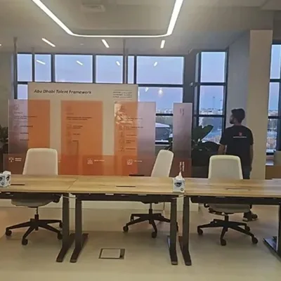 Orange-tinted acrylic display with MDF-clad boxes and branded scenic backdrop.