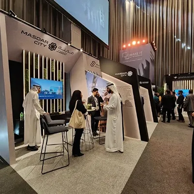 Evolution Scenic sponsor exhibition environment with angled walls and integrated display screens.