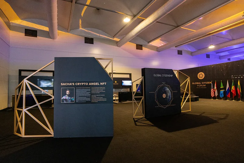 Geometric metal-framed displays installed beside the illuminated circular entrance feature.