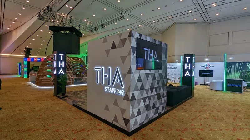 Vinyl-finished geometric wall with an integrated television and illuminated brand logo.