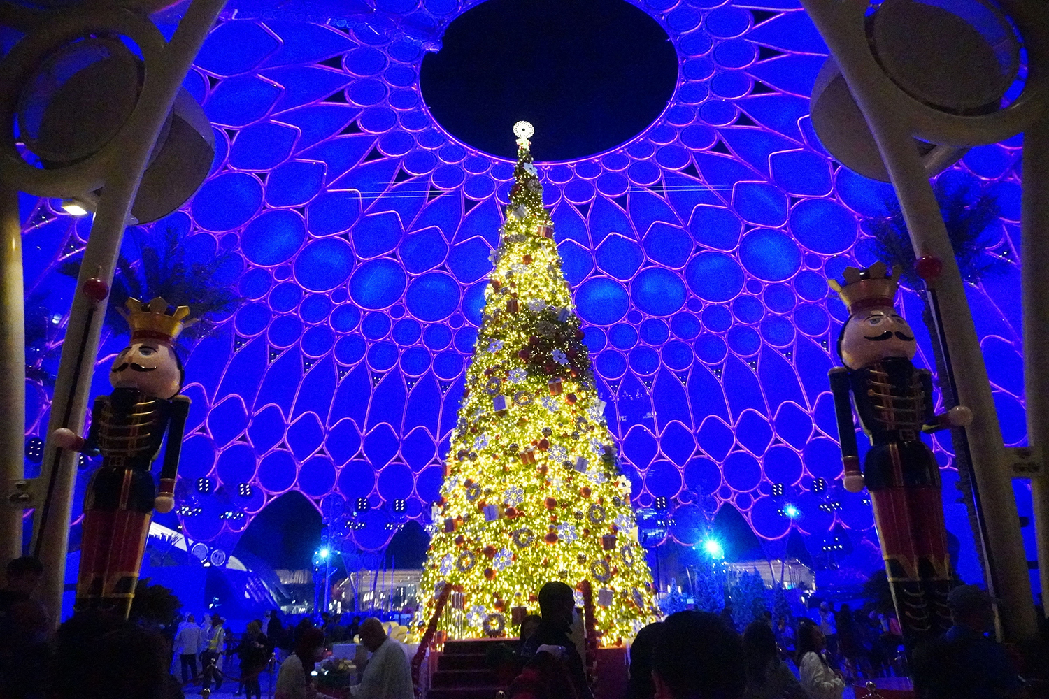 Giant nutcracker figures framing seasonal scenic installations across the Expo 2020 site.