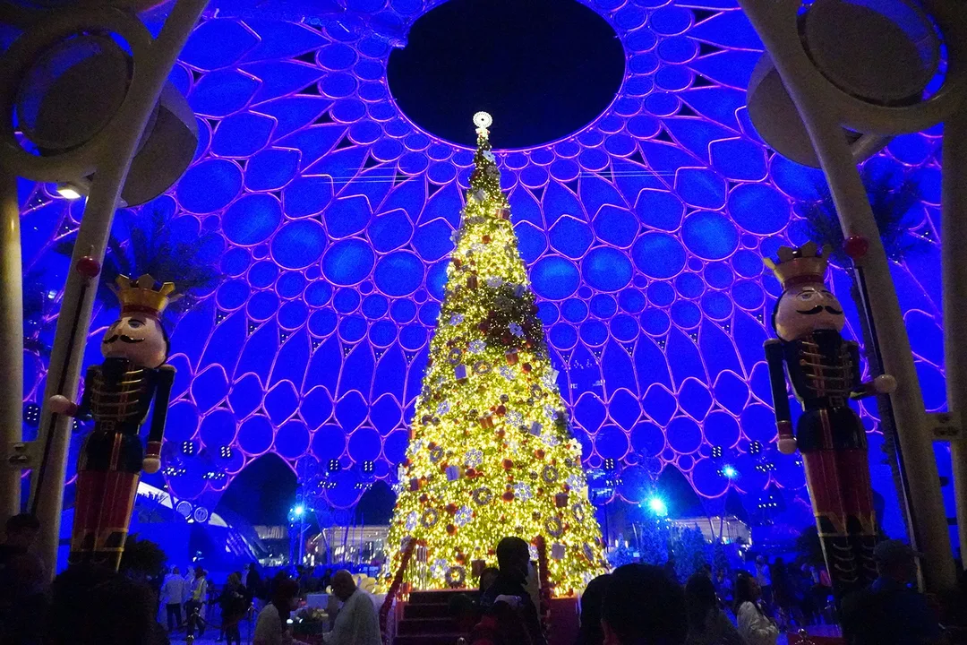 Giant nutcracker figures framing seasonal scenic installations across the Expo 2020 site.