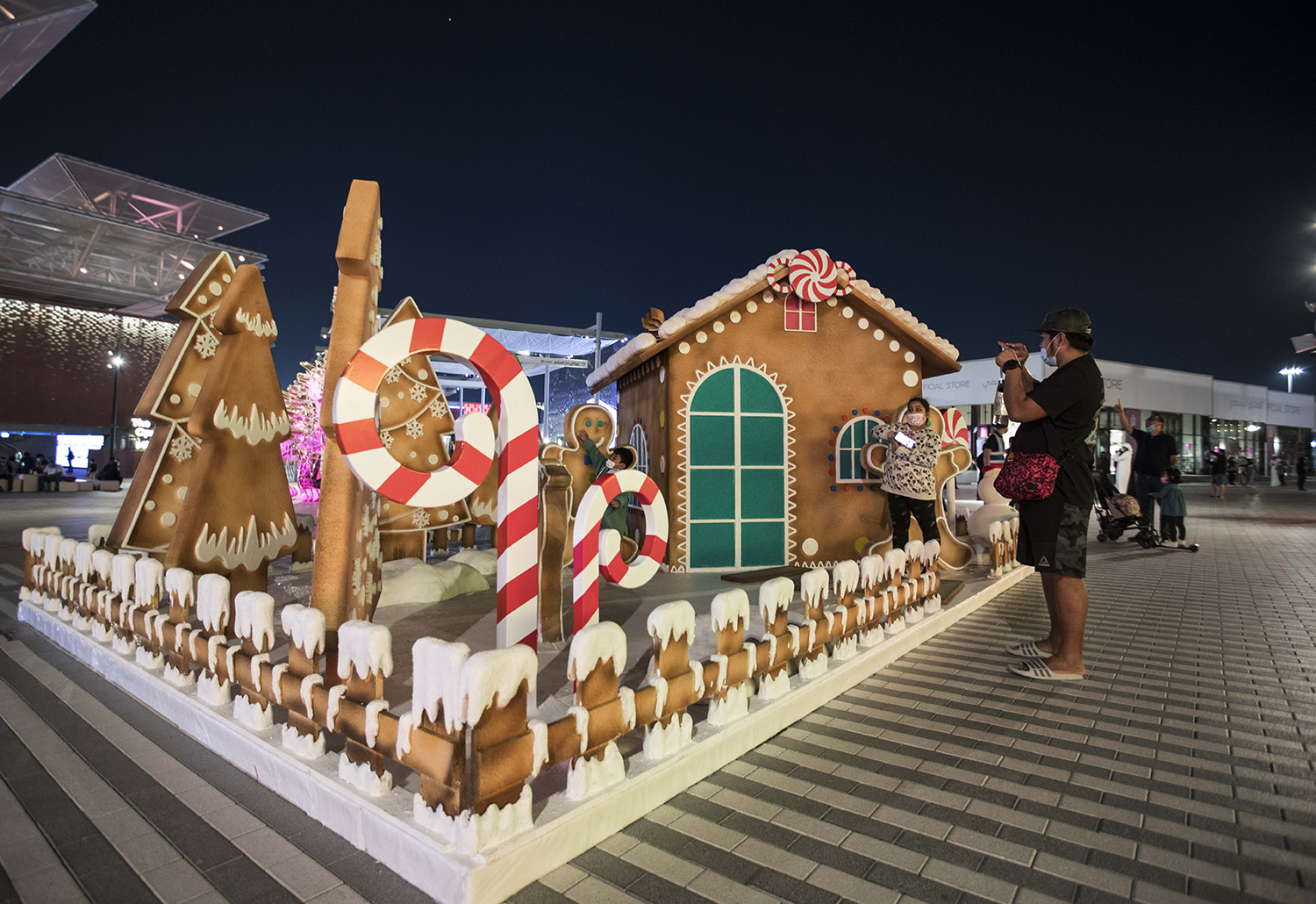 Gingerbread-style Santa’s House with layered confectionery scenic detailing and oversized festive props.