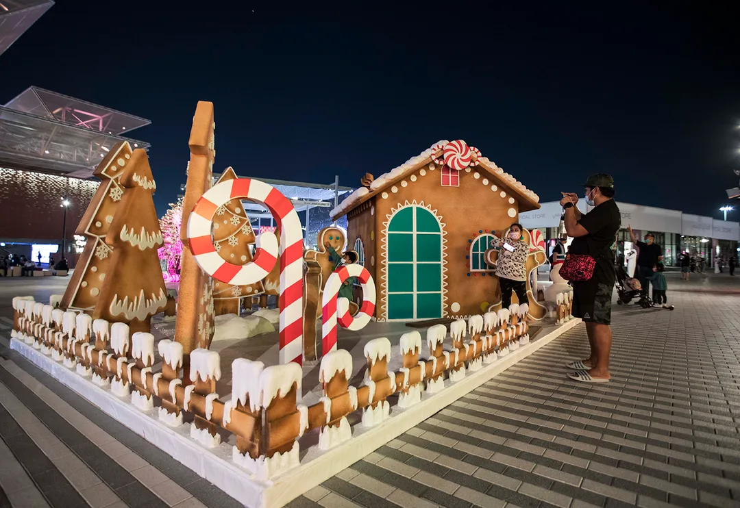 Gingerbread-style Santa’s House with layered confectionery scenic detailing and oversized festive props.