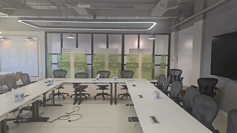 Green-tinted acrylic workshop stand with transparent graphics and printed MDF backdrop.