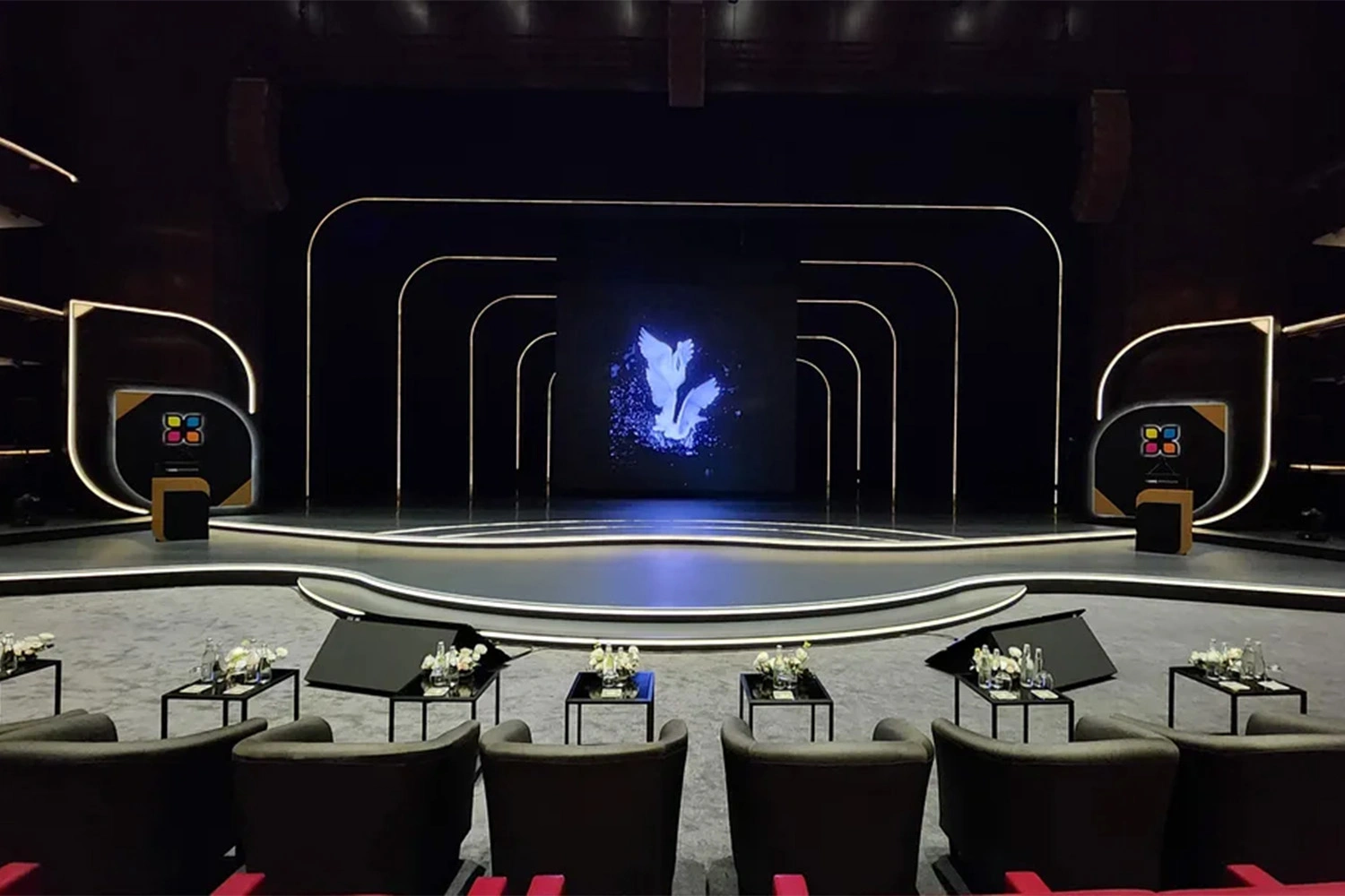 Conference stage black drape masking AV cabling and technical access areas
