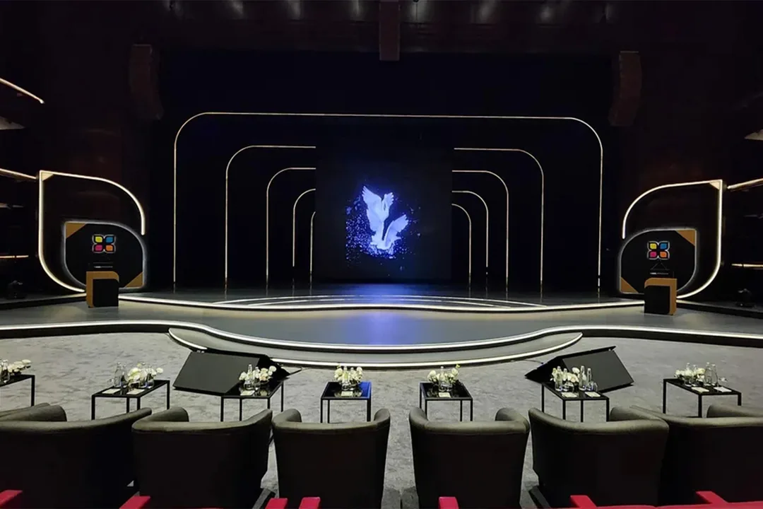 Conference stage black drape masking AV cabling and technical access areas
