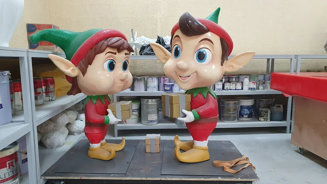 Evolution Scenic sculptural elves positioned alongside chalet structures and themed winter scenery.
