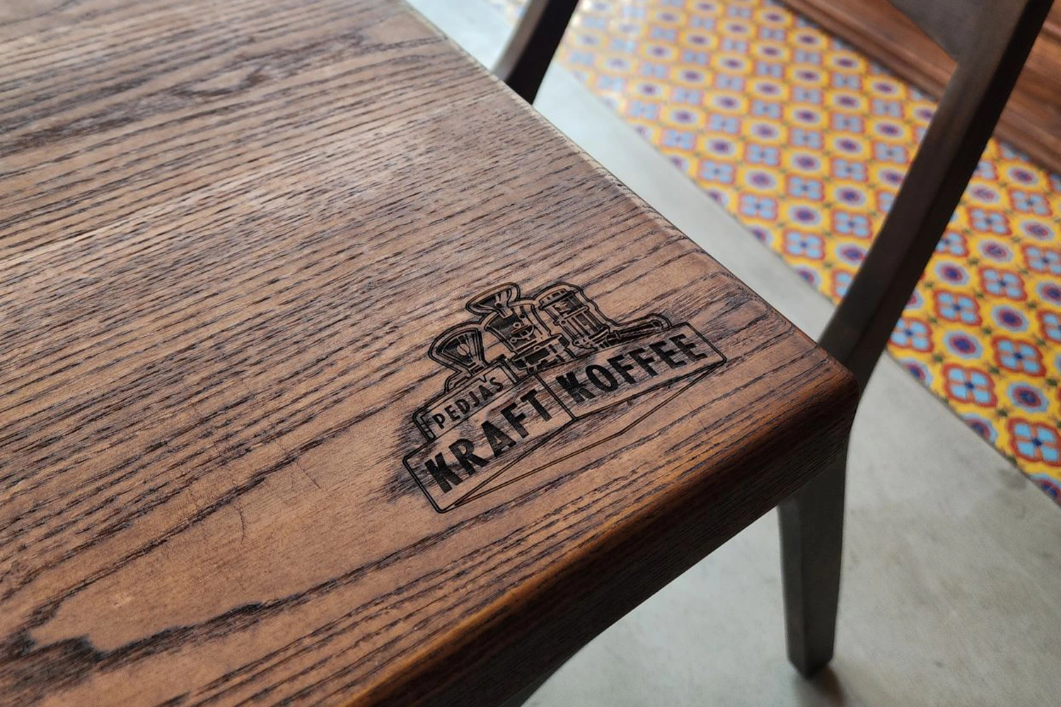 Bespoke walnut table tops fabricated by Evolution Scenic for the coffee shop interior.

