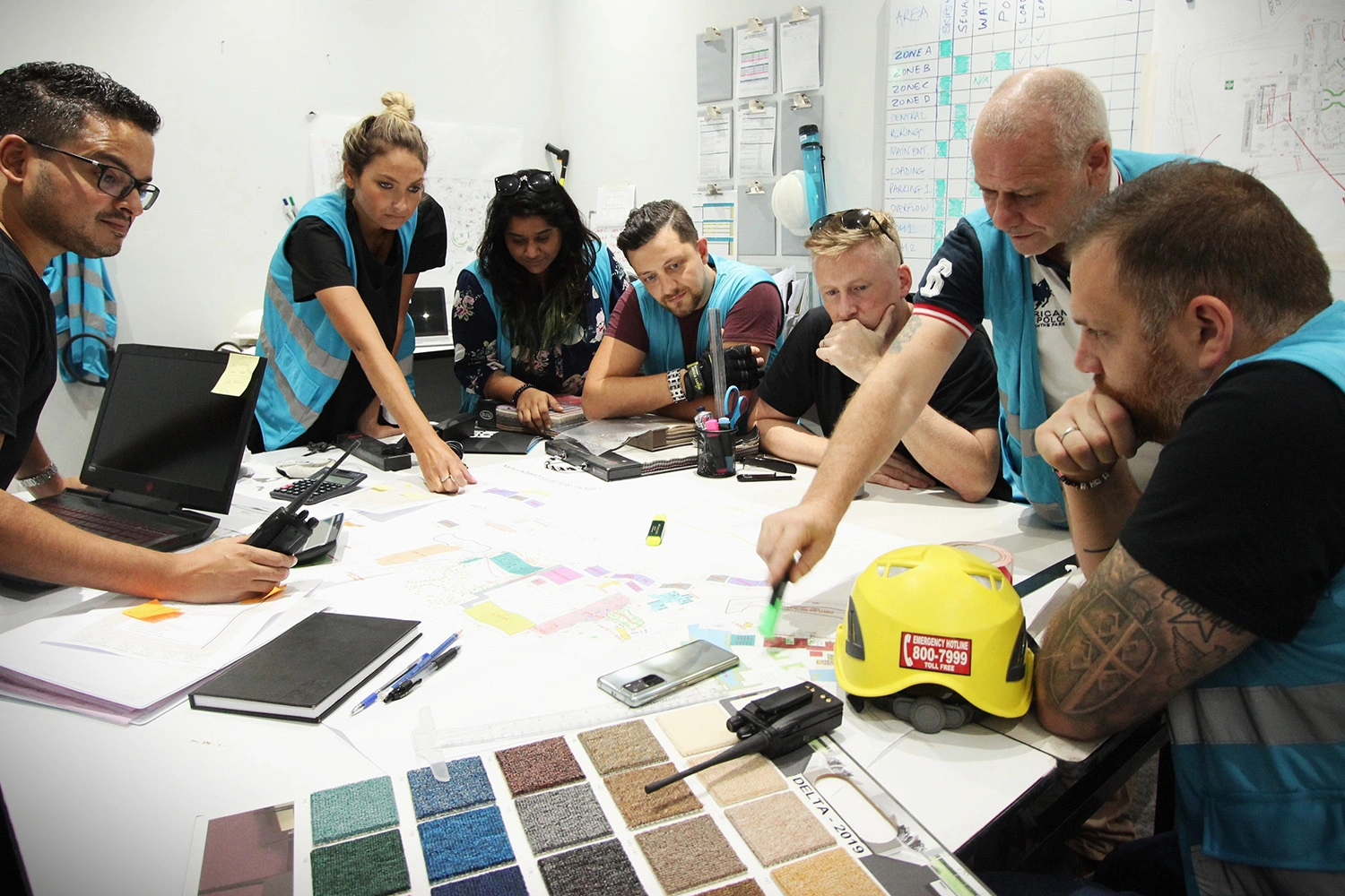 Scenic fabrication team resolving buildability details around a full-size prototype
