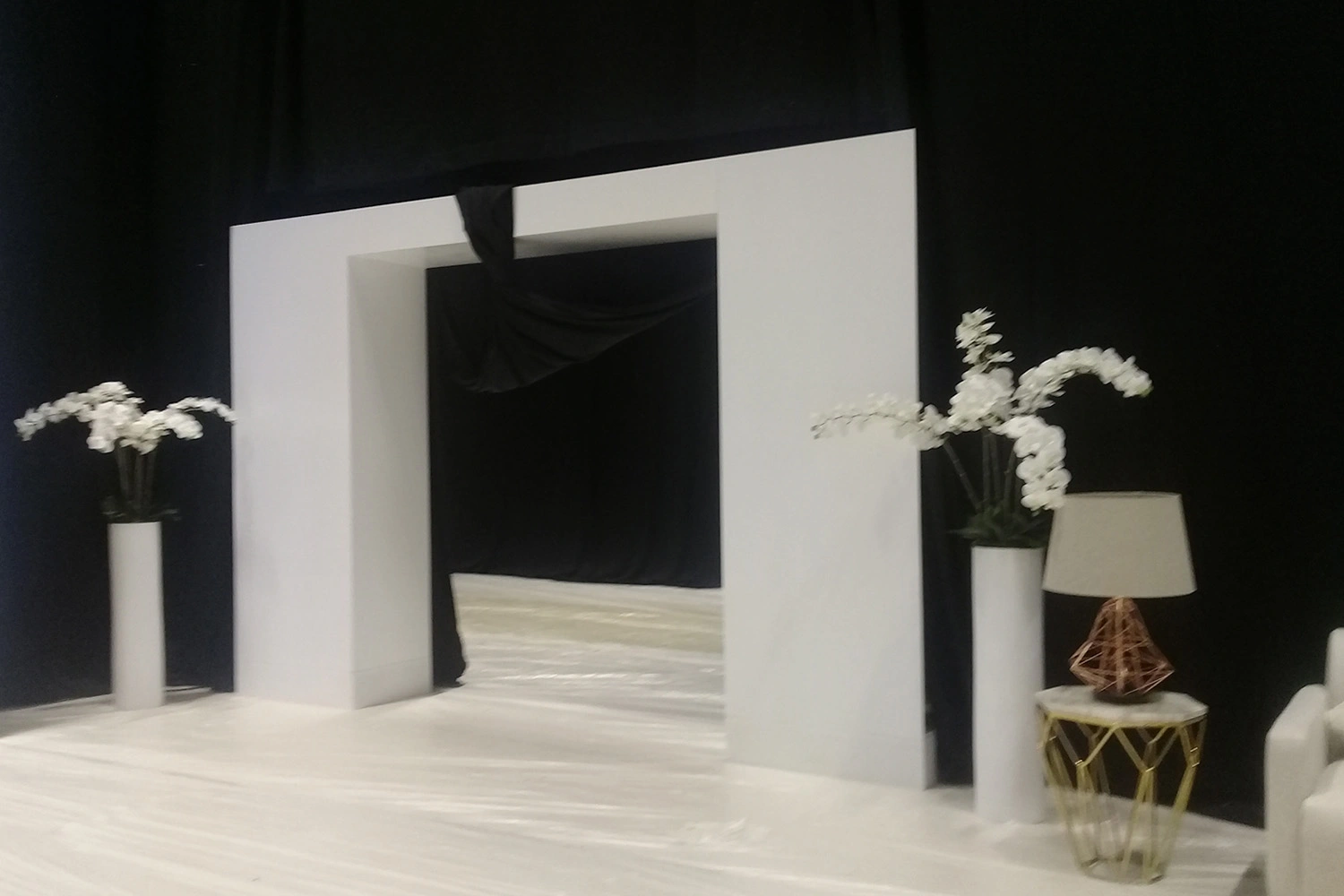 Overlapping black drape masking system forming a concealed backstage access point
