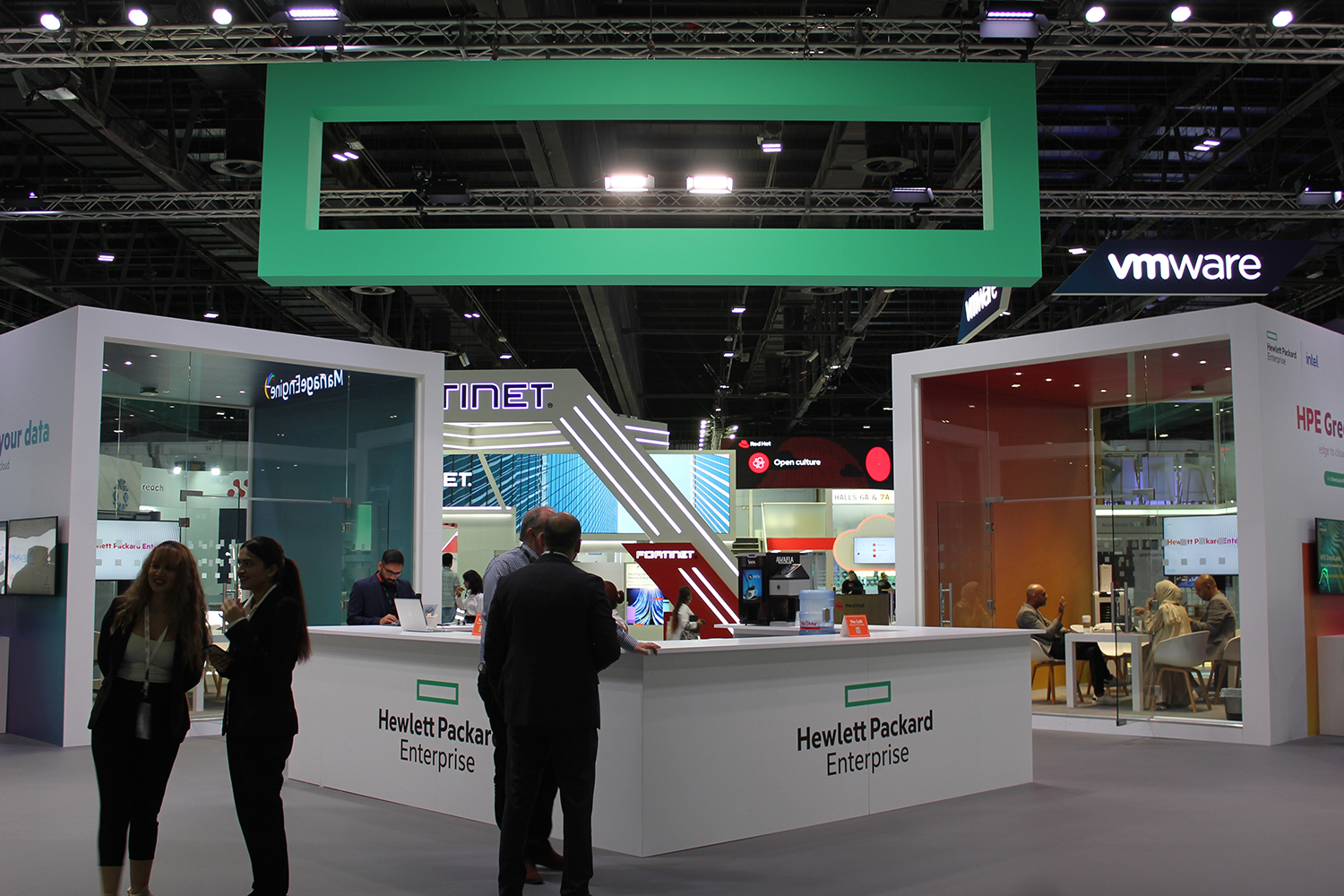 Completed HPE GITEX Dubai stand with bespoke scenic structures and glazed meeting-room architecture.