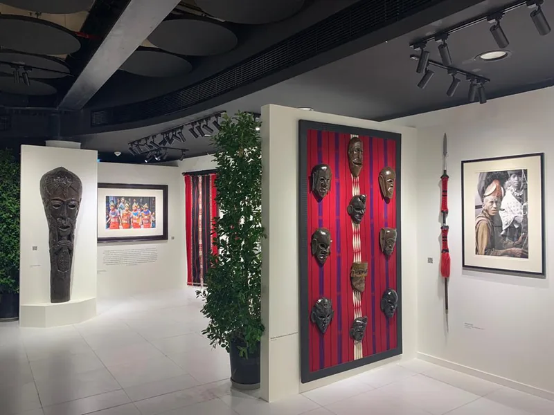 Custom exhibition flooring and skirting connecting black and white gallery environments.