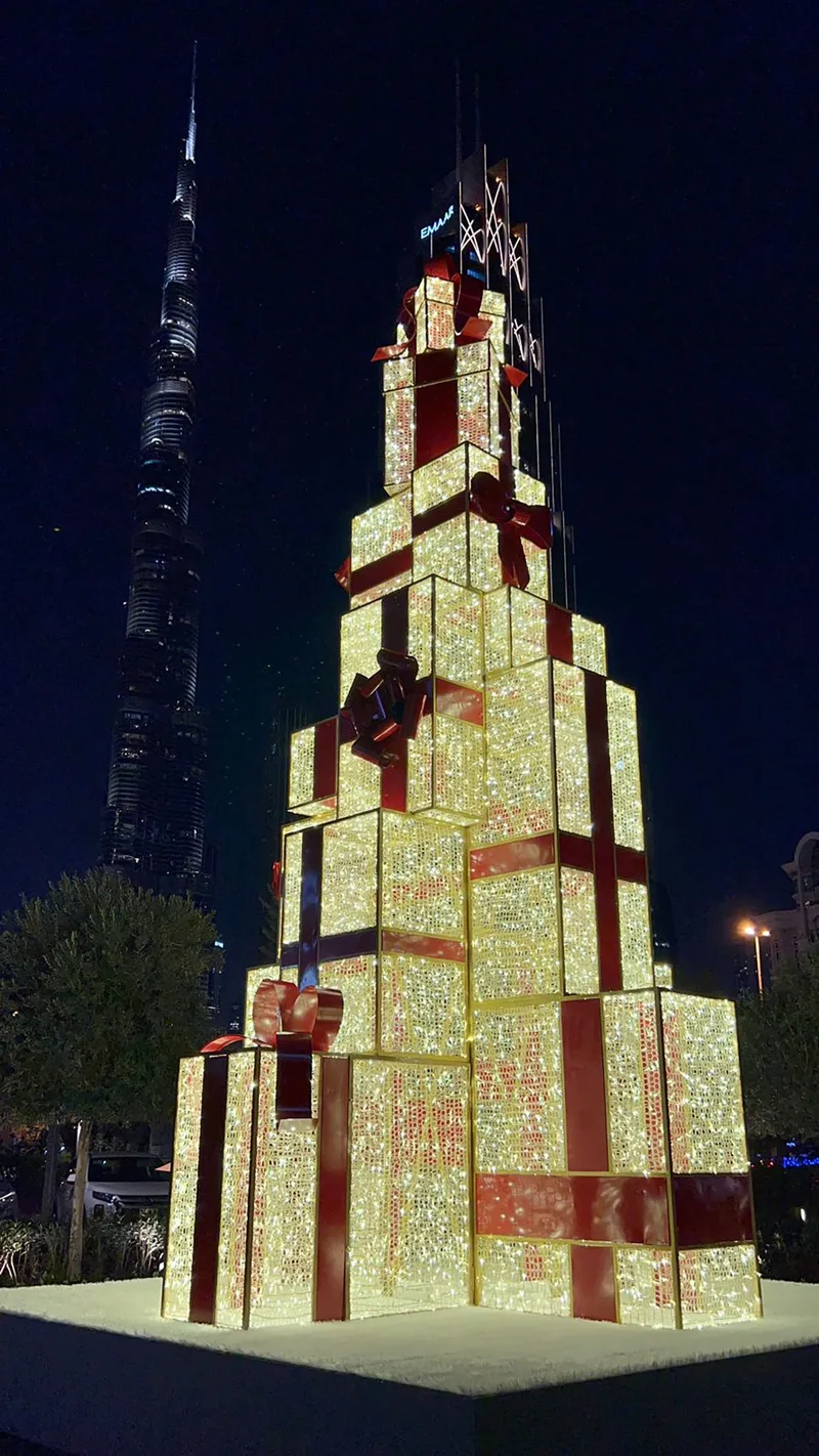 Illuminated stacked gift-box tower refurbished for a large-scale Dubai Christmas display