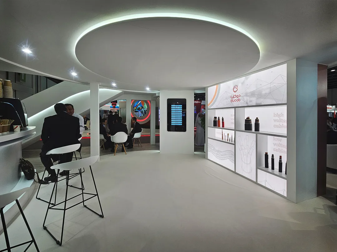 Fire-retardant MDF product wall with illuminated glass shelves and acrylic graphic panels.