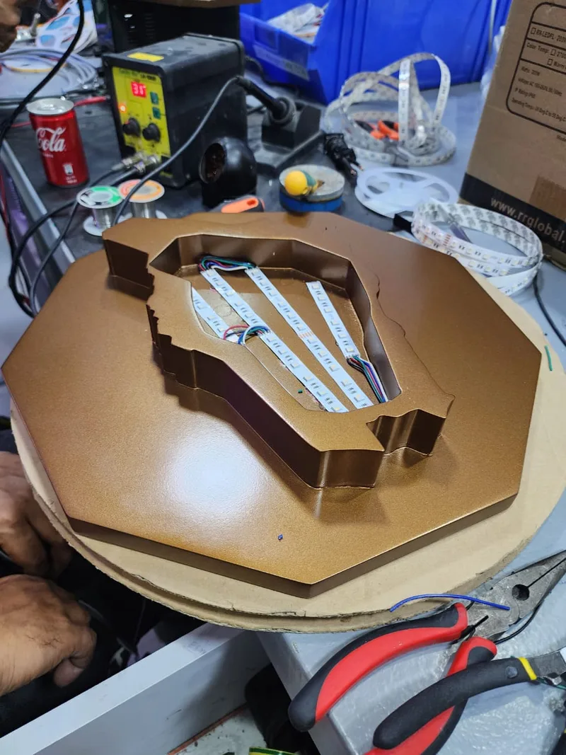Illuminated poured-resin emblem integrated within the custom faceted scenic structure. 