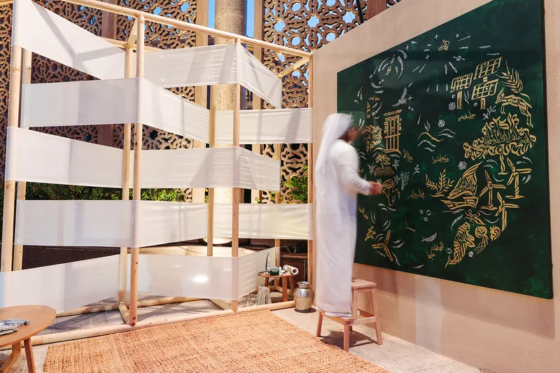 Custom cultural feature wall beside a timber-framed fabric scenic screen at Pre-COP28.