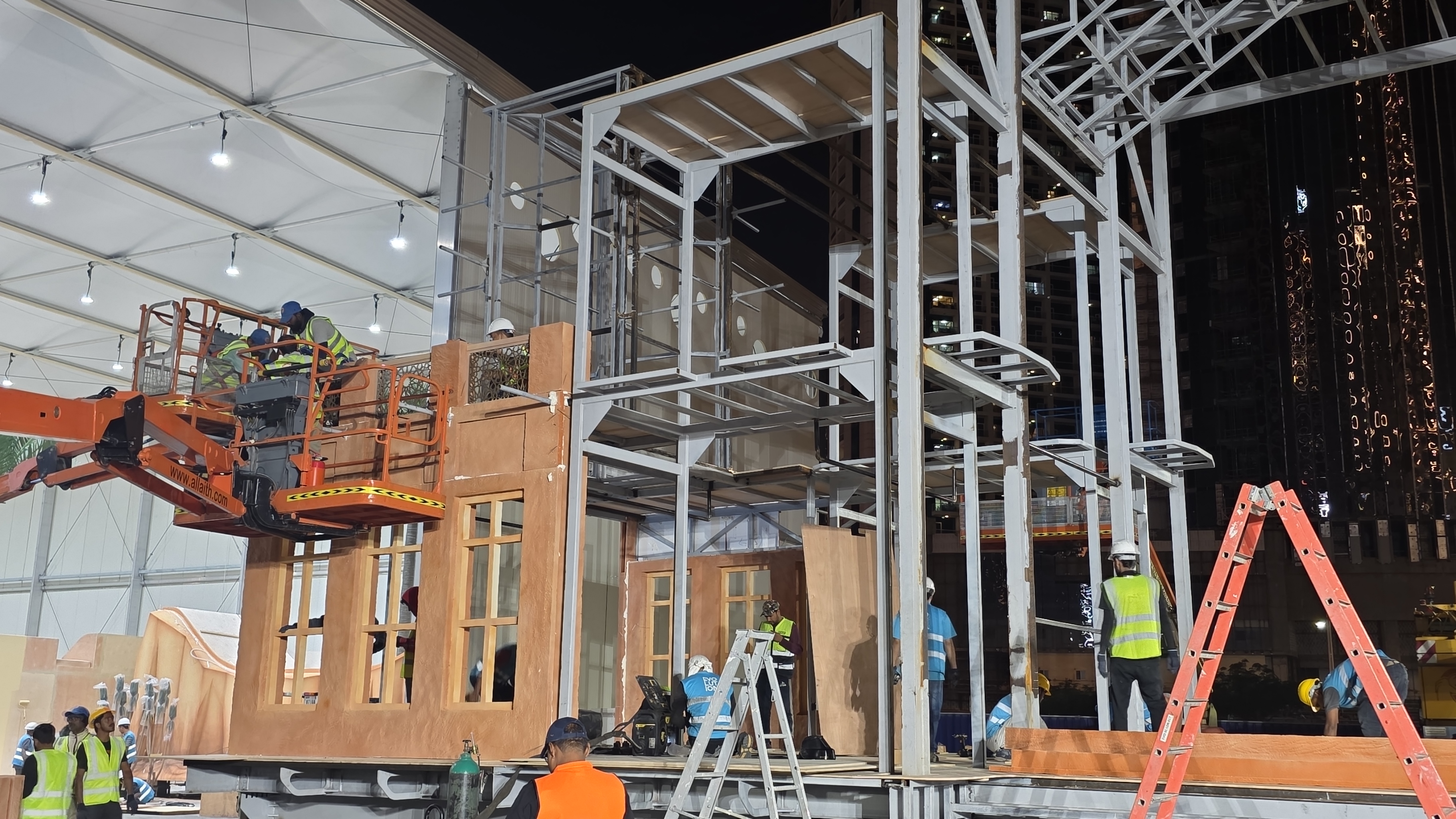 Installation crew assembling steel modules before fitting scenic finishes and lighting.

