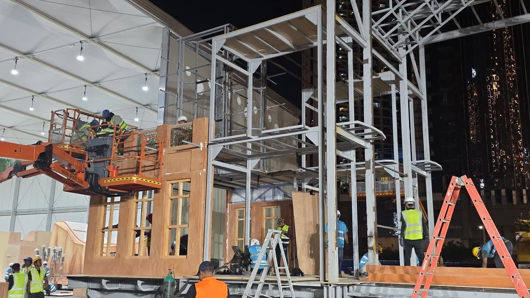 Installation crew assembling steel modules before fitting scenic finishes and lighting.
