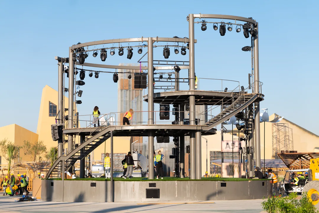 Large scenic stage combining primary steelwork, secondary framing, decking and overhead structural systems.