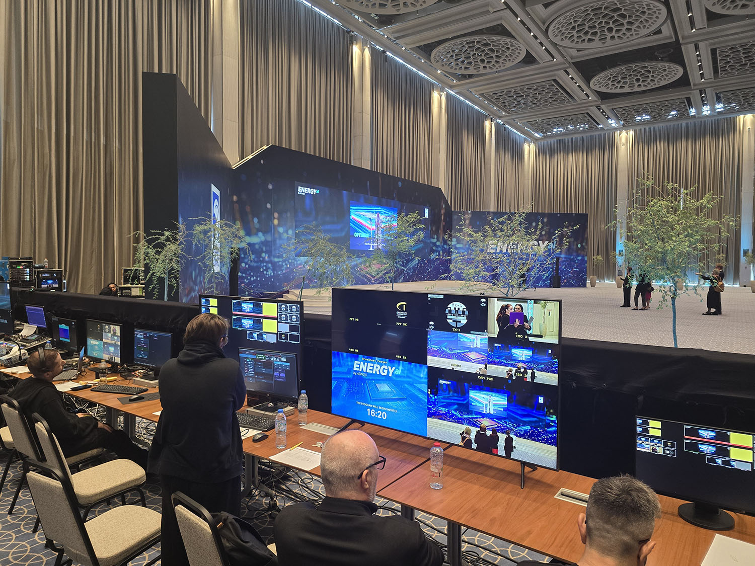Dark graphic scenic walls framing digital displays at the ADNOC Energy Center.