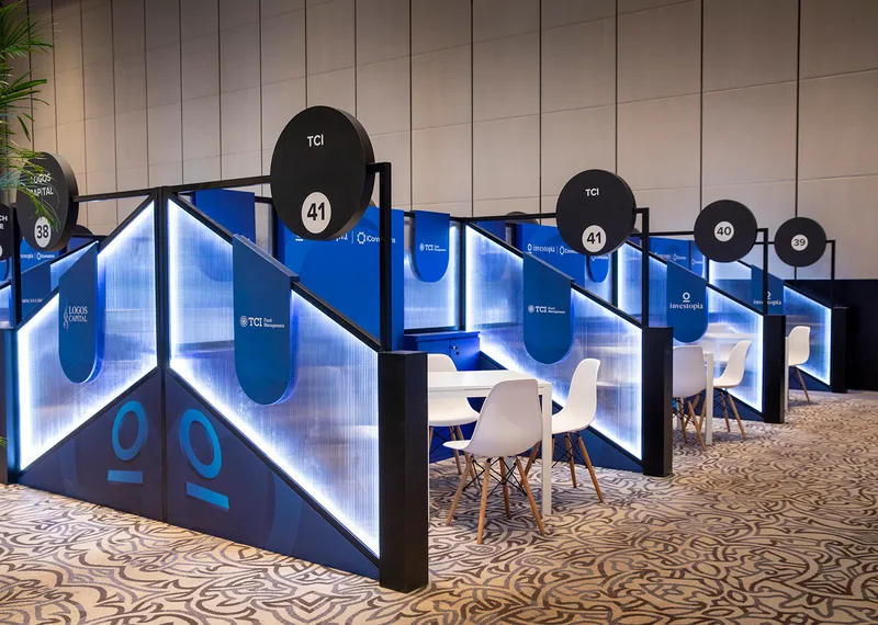 Evolution Scenic Investopia networking booths with integrated storage cabinets and branded scenic partitions.