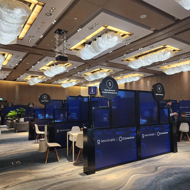 Evolution Scenic fabricated meeting booths with blue partitions and circular identification signs.