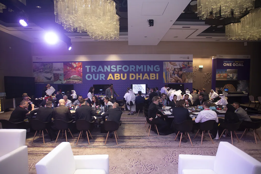 Large printed perimeter walls dividing workshop zones inside the hotel ballroom.