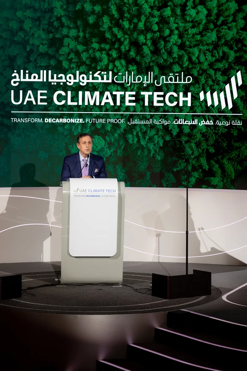 Evolution Scenic custom lectern integrated into the illuminated conference stage construction.