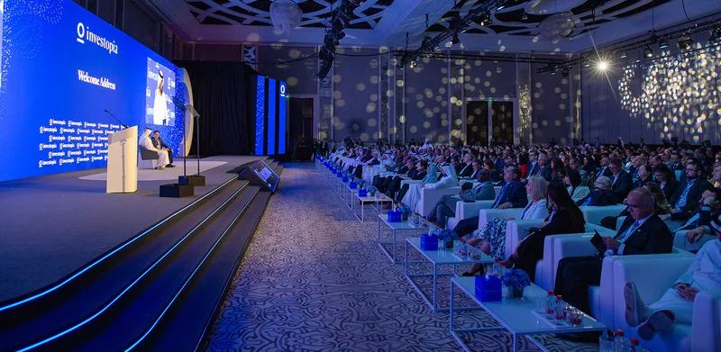 Carpet-finished main stage with LED-lit steps and an integrated lightbox logo fascia.