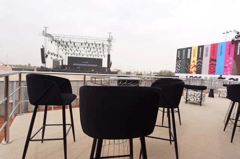 Custom VIP seating platform with carpet finish, seating and perimeter handrails at LIV Golf Riyadh 2025.