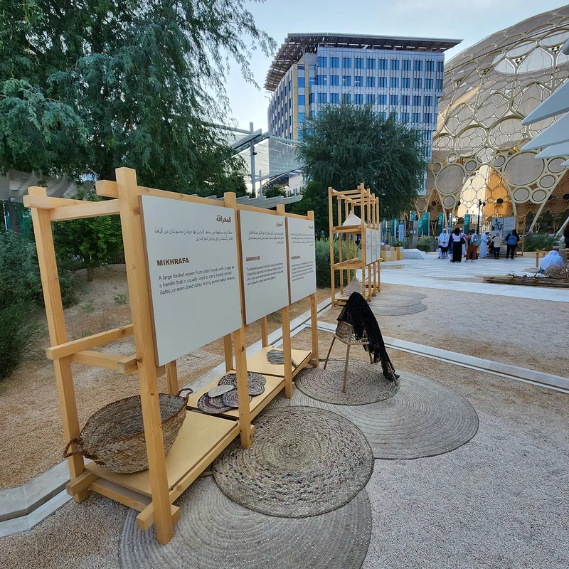Timber shelving and interpretive panels forming the UAE Pavilion cultural scenic environment.