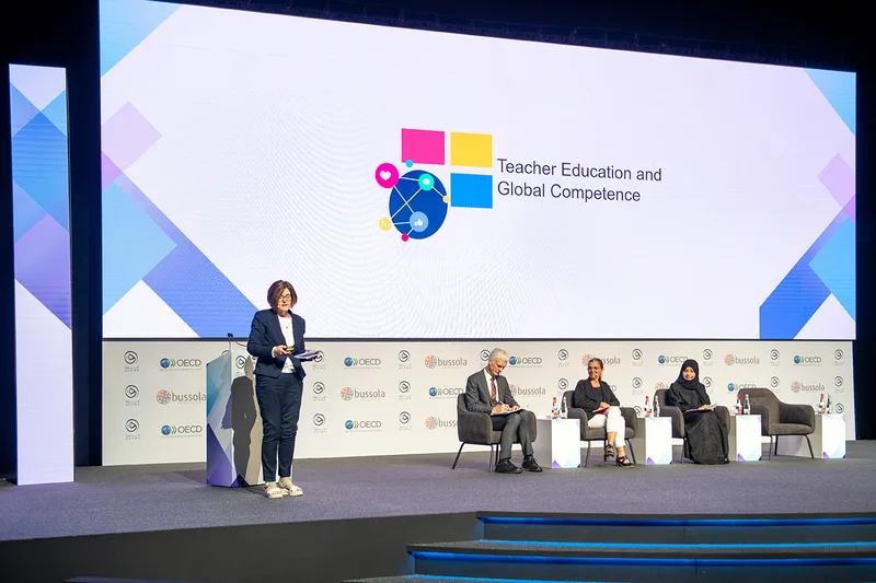 Modular stage deck with framed LED screen integration for the Qudwa–PISA Forum.