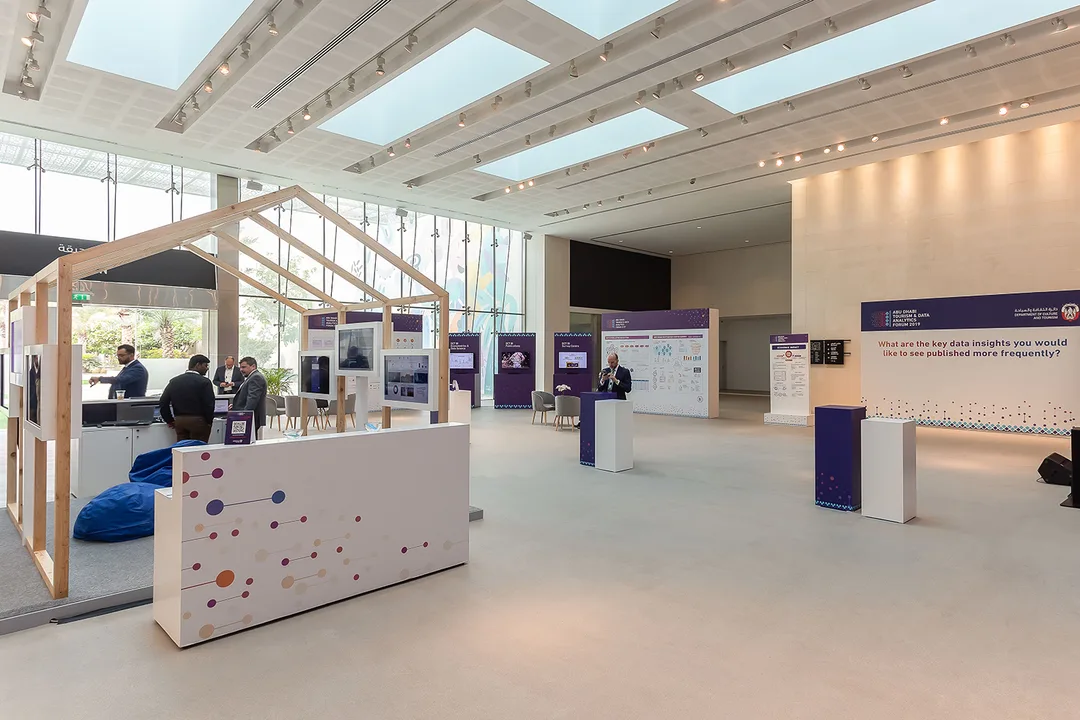 Evolution Scenic networking counter and branded partition within the forum venue.
