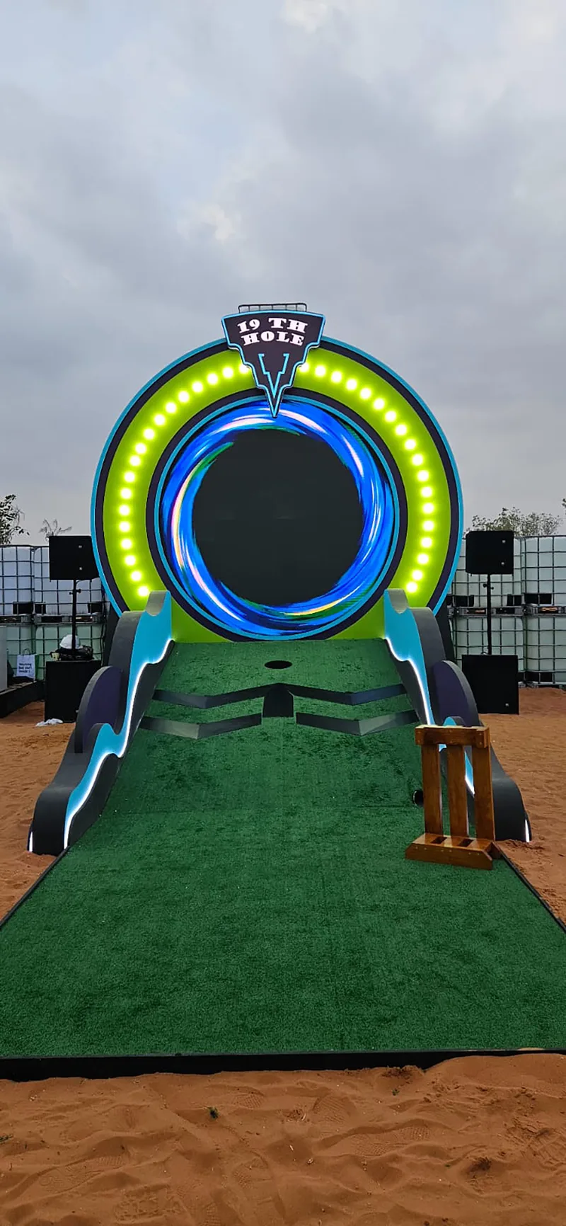 Custom putting ramp leading through a colour-changing circular scenic light feature.