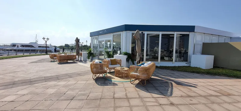 Branded waterfront hospitality environment with integrated furniture and custom scenic construction.